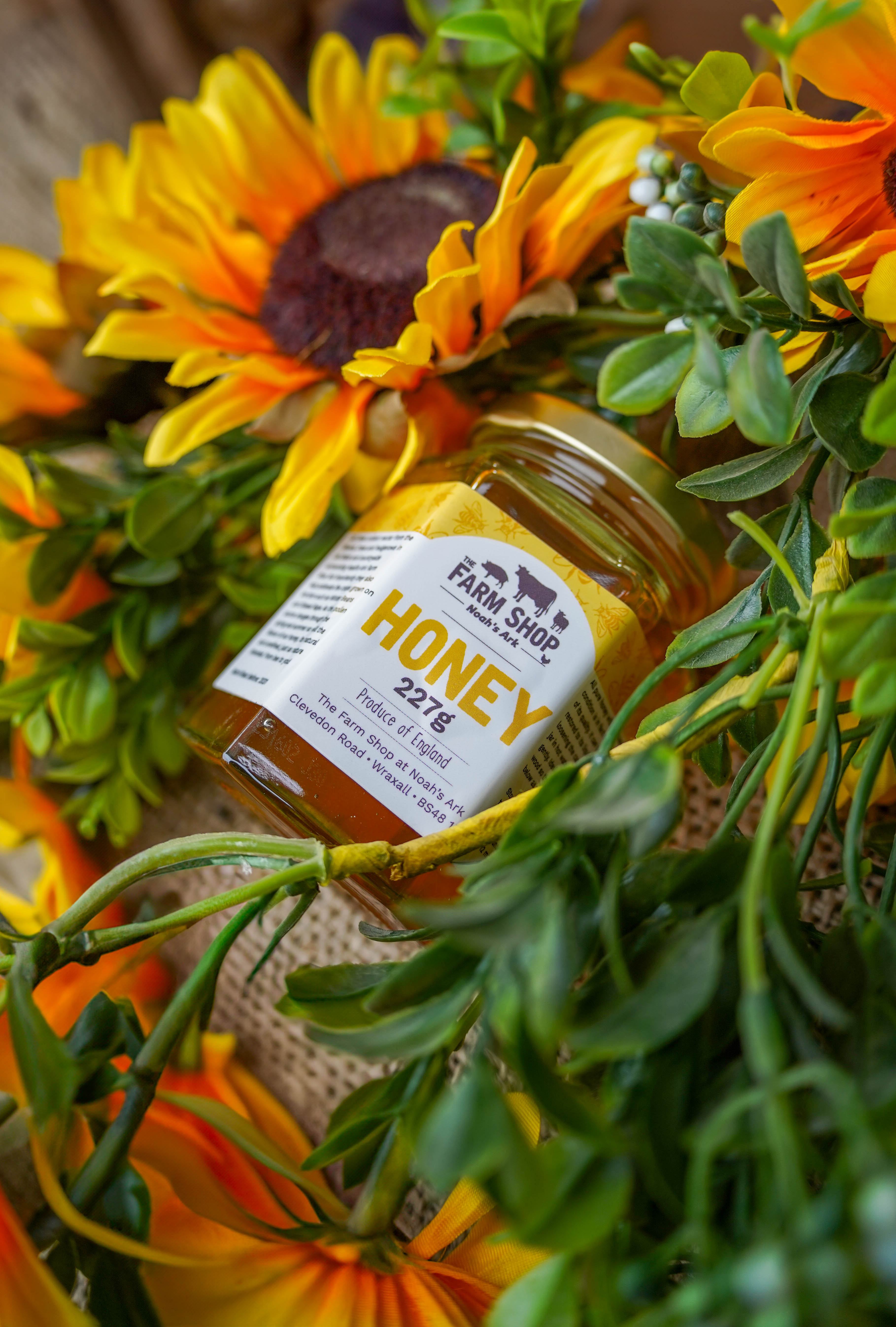 Noah Ark Farm Shop's jar of honey, decorated with artificial sunflowers. 