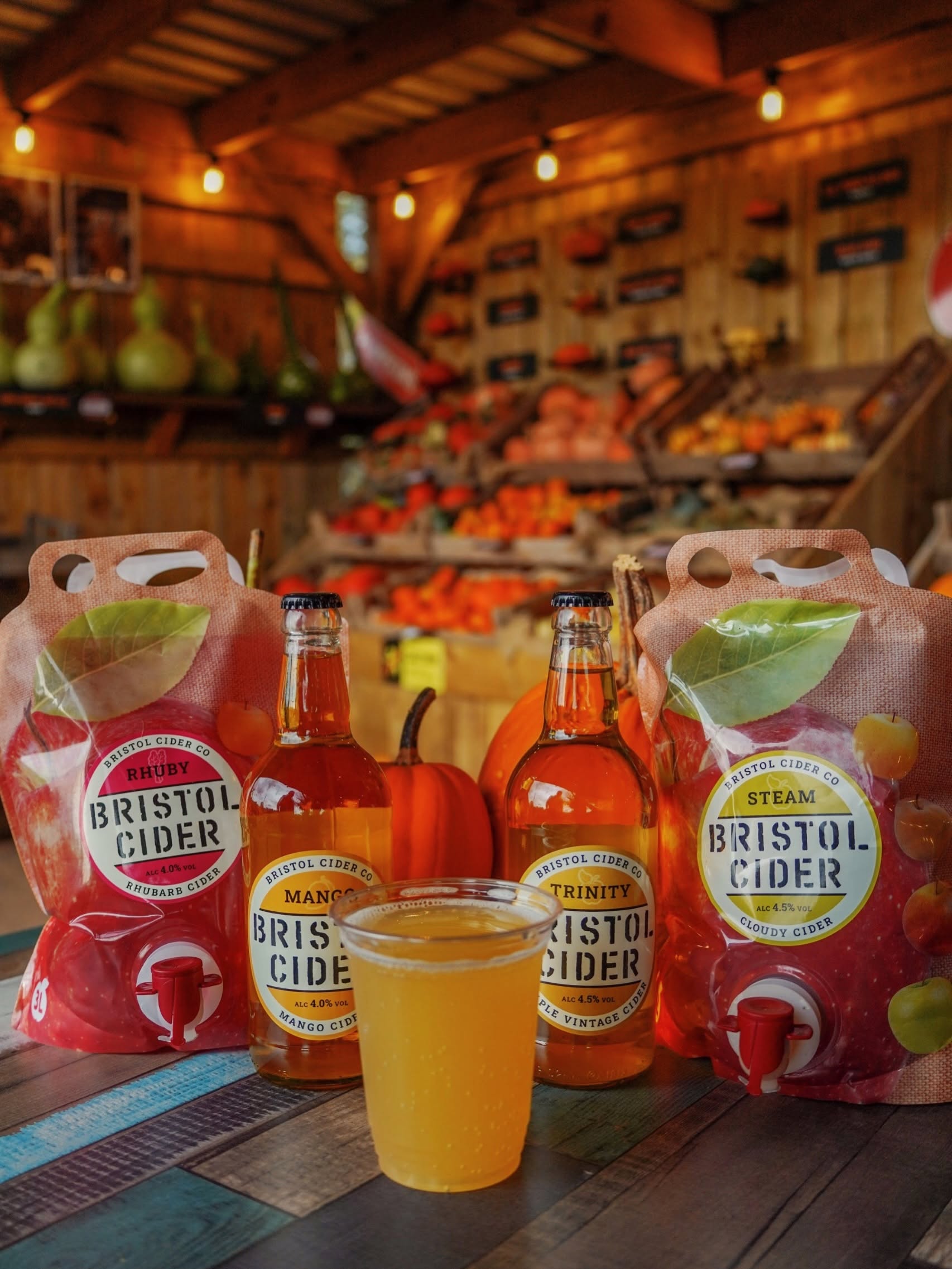 Bristol cider products, with pumpkins displayed in the background. 